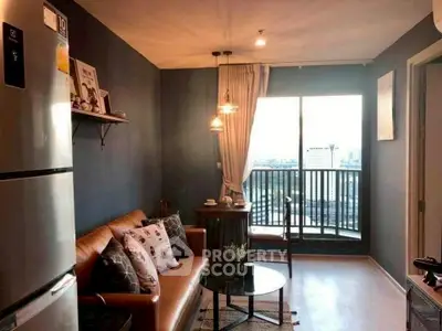 Chic living room with modern decor and balcony view, perfect for urban living.