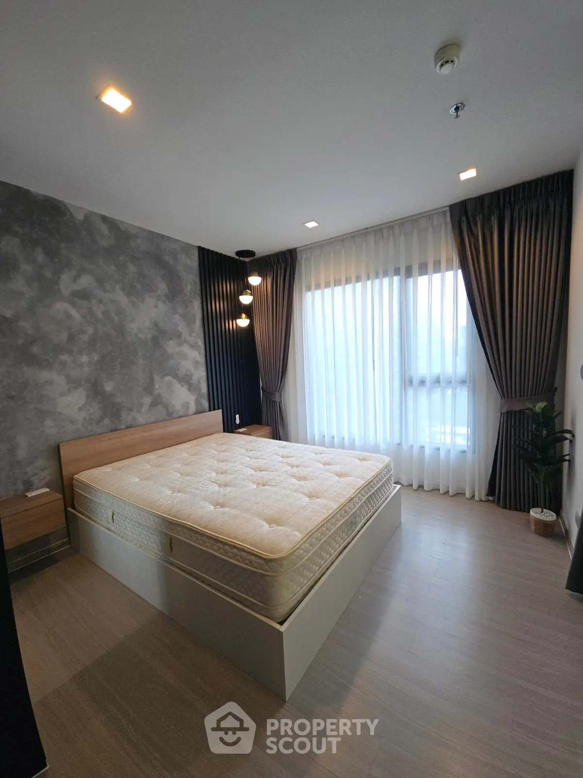 Modern bedroom with stylish decor and large window for natural light