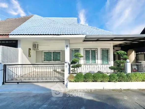 Charming single-story house with manicured garden and modern facade