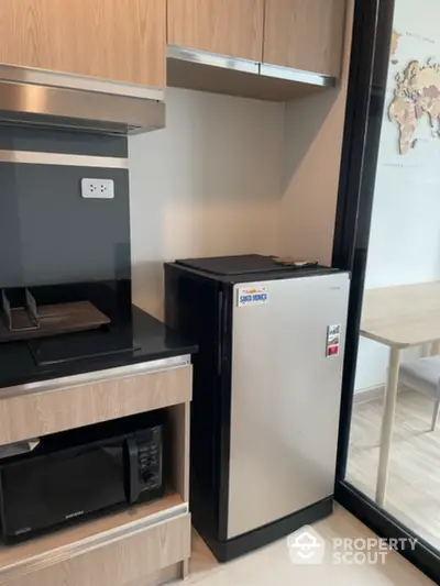 Modern kitchen with sleek appliances and stylish cabinetry in a contemporary apartment.