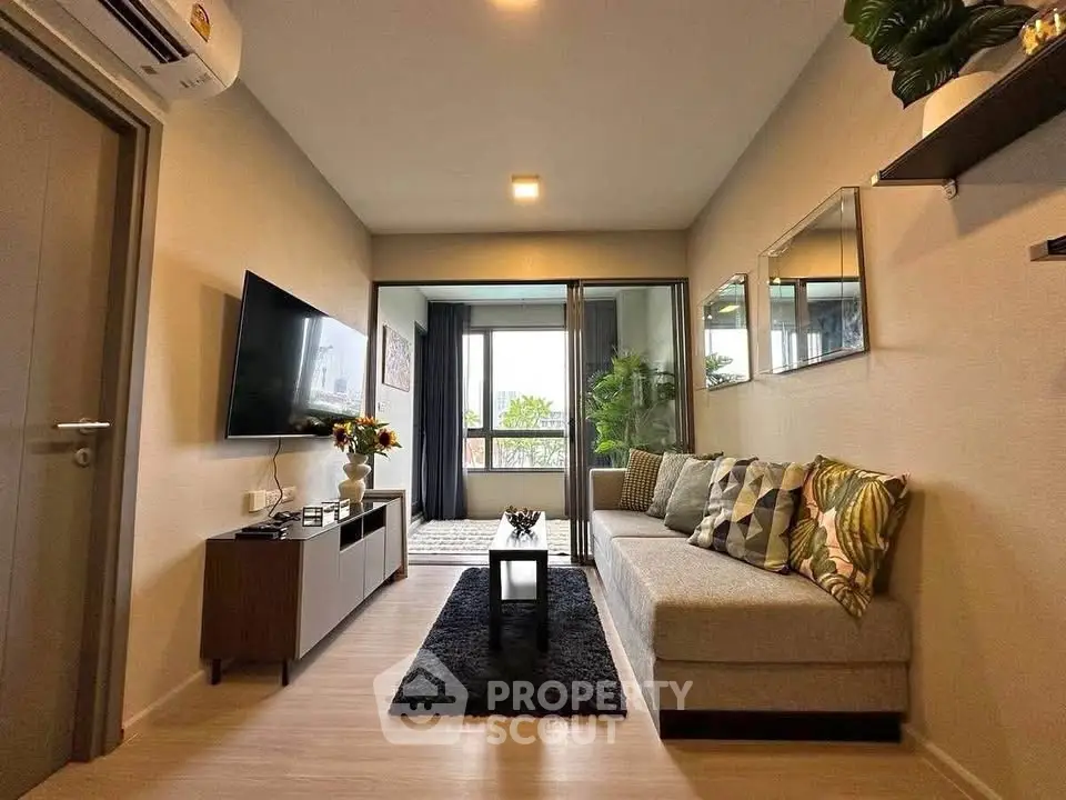 Modern living room with stylish decor and balcony view in a cozy apartment.