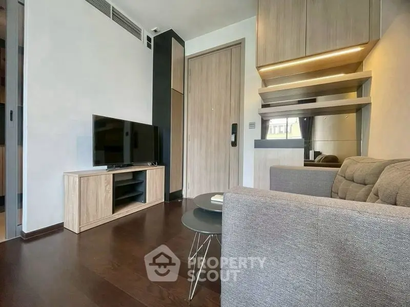 Modern living room with sleek furniture and wooden flooring