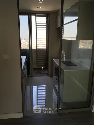 Modern kitchen with sleek design and city view from balcony