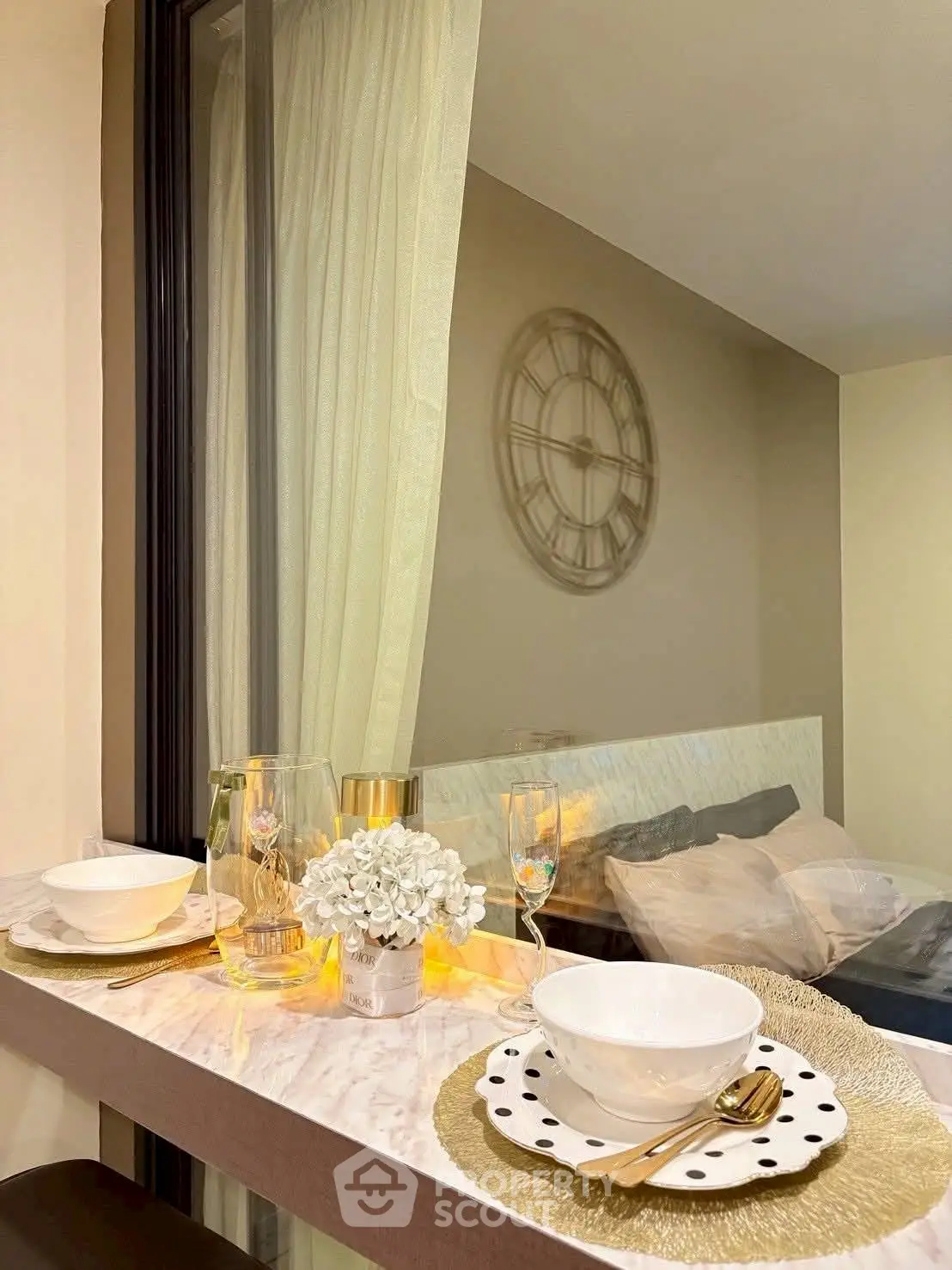 Chic dining setup with elegant tableware and cozy bedroom view.