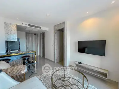 Modern living room with sleek decor and wall-mounted TV in a stylish apartment.