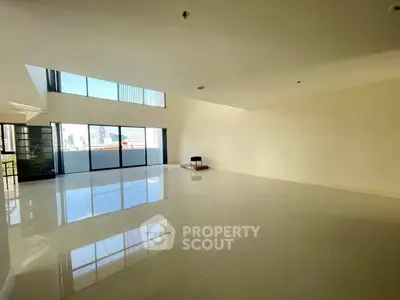 Spacious empty living room with large windows and city view, perfect for customization.
