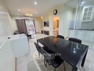 Modern open-plan living and dining area with sleek kitchen and stylish decor