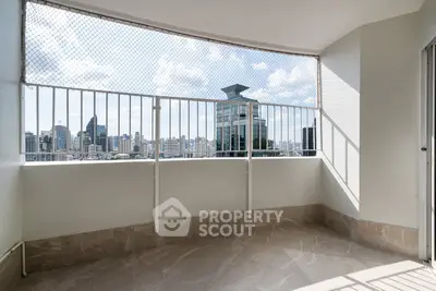 Spacious balcony with stunning city skyline view, perfect for relaxation and enjoying urban living.