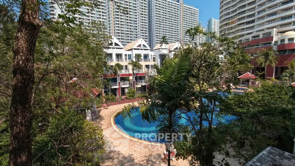 Luxurious residential complex with pool and lush greenery, offering a serene urban oasis.