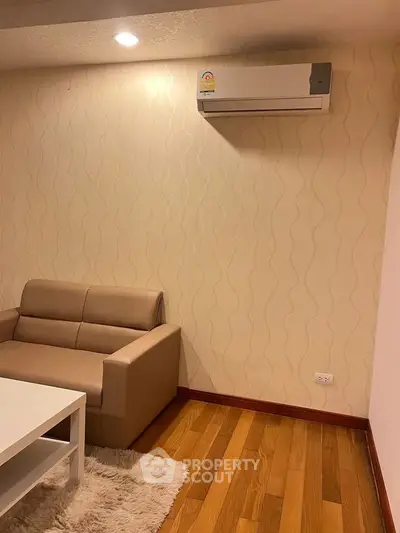Cozy living room with modern air conditioning and stylish furniture, perfect for relaxation.