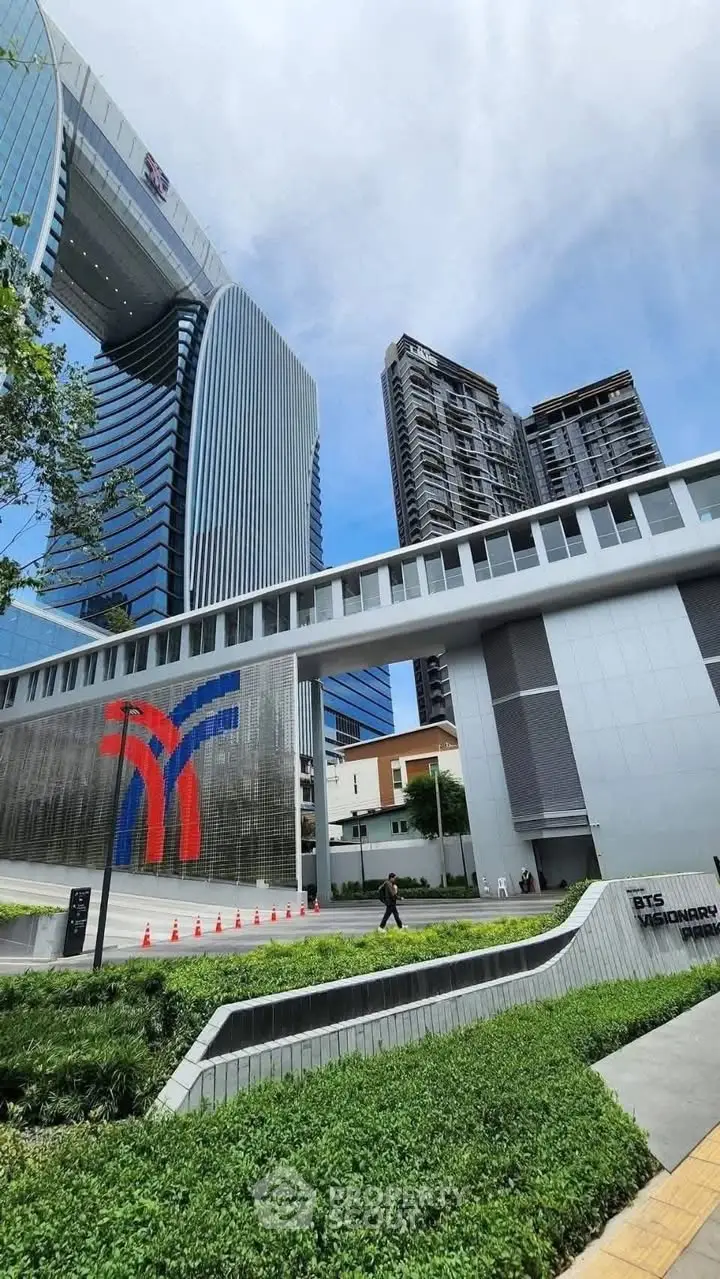 Modern architectural marvel with sleek skyscrapers and lush greenery in urban setting.