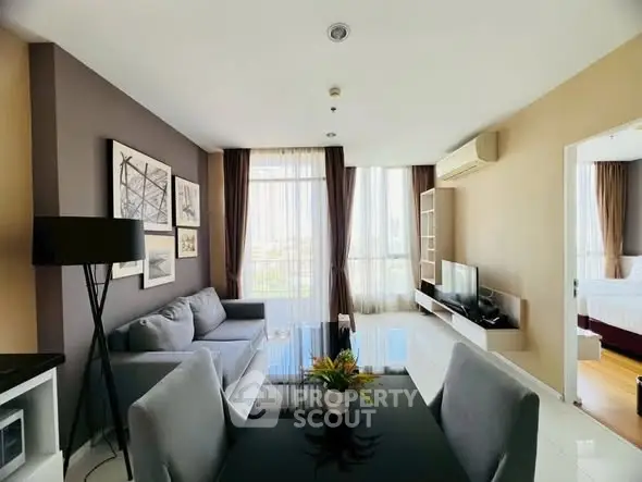 Modern living room with stylish decor and natural light in a contemporary apartment.