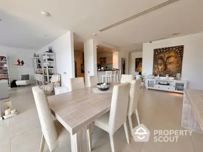 Spacious open-plan living and dining area with modern decor and natural light.