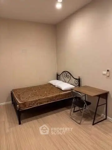 Cozy bedroom with minimalist decor and wooden flooring