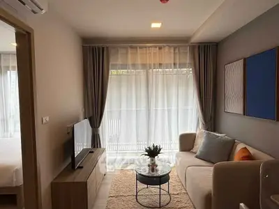 Cozy living room with modern decor and large window for natural light