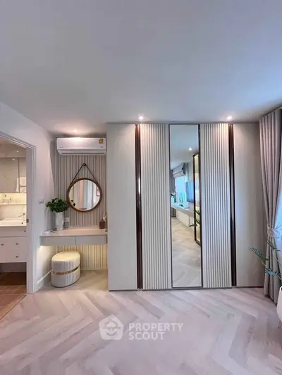 Stylish bedroom with mirrored wardrobe and elegant decor