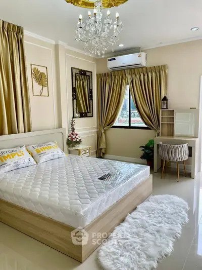 Luxurious bedroom with elegant decor, chandelier, and plush furnishings for a sophisticated living experience.