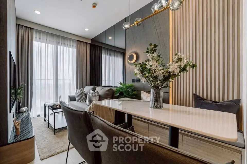Modern living room with elegant decor, large windows, and stylish furniture, perfect for urban living.