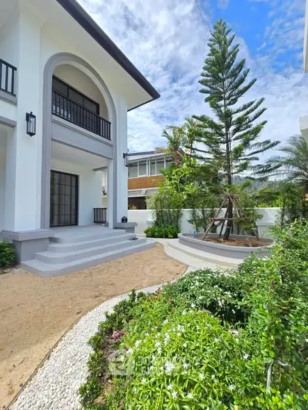 Elegant modern home exterior with lush garden and inviting entrance