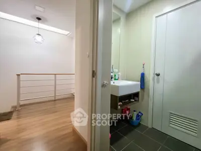 Modern interior with hallway and bathroom, featuring sleek design and contemporary lighting.