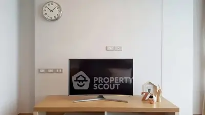 Modern living room with sleek TV setup and minimalist decor.