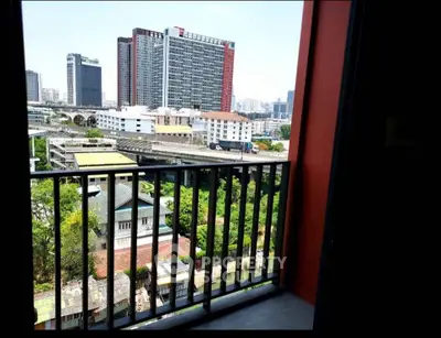 Stunning urban view from a high-rise balcony overlooking cityscape and greenery, perfect for modern living.