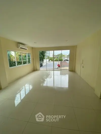 Spacious unfurnished living room with large windows and natural light