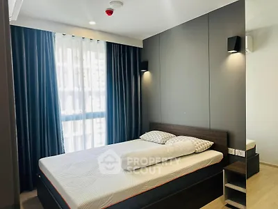 Modern bedroom with stylish decor and natural light in a contemporary apartment.