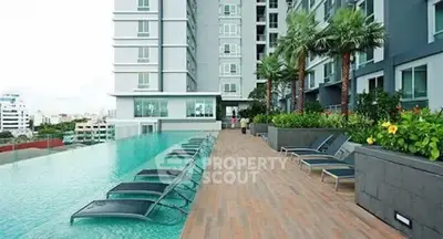 Luxurious rooftop pool with city view and modern lounge chairs