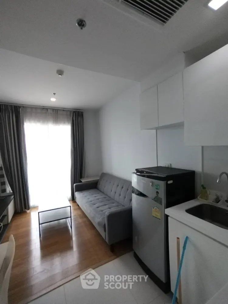 Modern compact living room with kitchenette and natural light