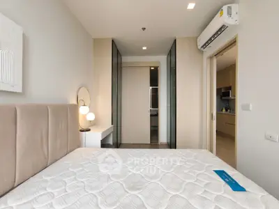 Modern bedroom with stylish decor and air conditioning, featuring a cozy bed and elegant lighting.