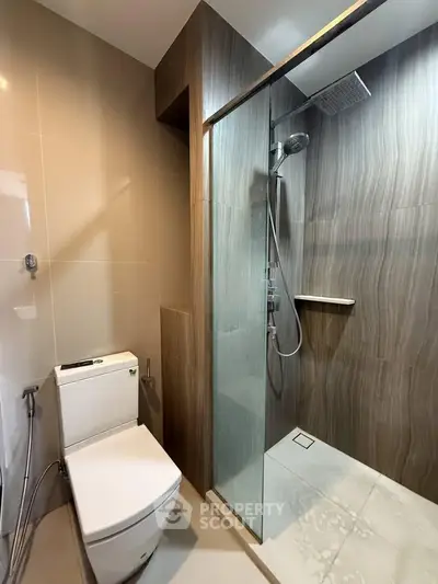 Modern bathroom with sleek shower and toilet in contemporary design.