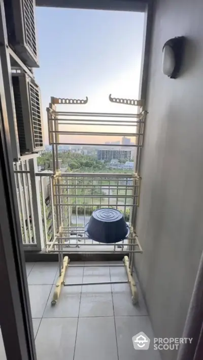 Charming balcony with city view and drying rack, perfect for urban living.