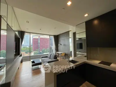 Modern open-layout living room with kitchen, large windows, and city view in a stylish apartment.