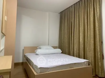 Cozy bedroom with modern wooden furniture and elegant gold curtains, perfect for restful nights.