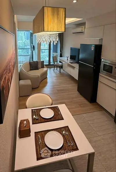 Modern open-layout kitchen and living room with city view, elegant lighting, and sleek appliances.