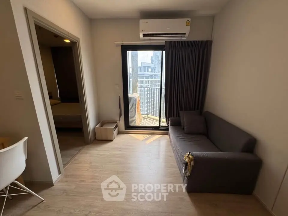 Modern living room with balcony access and air conditioning in a stylish apartment.