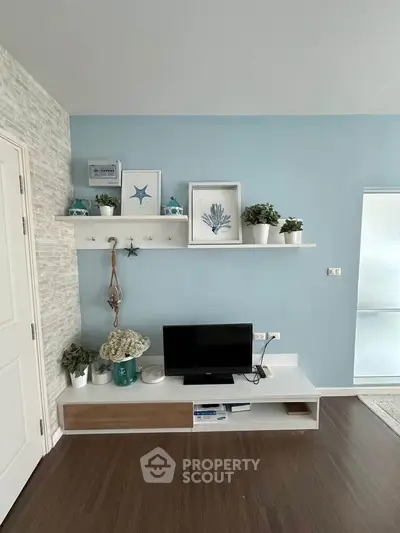 Stylish living room with modern decor and wall-mounted TV unit, perfect for cozy family gatherings.