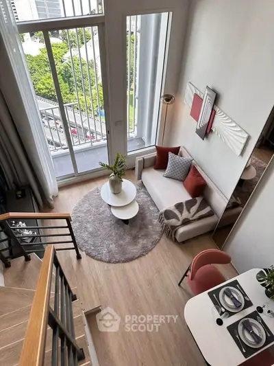 Modern loft-style living room with high ceilings and large windows