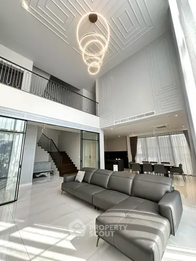 Luxurious modern living room with high ceiling and elegant lighting