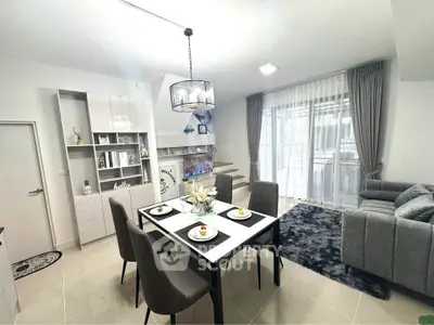 Modern dining and living area with elegant decor and natural light