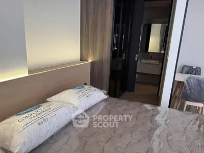 Modern bedroom with stylish decor and cozy bedding in a contemporary apartment.