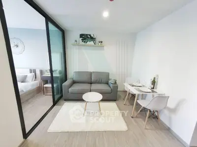 Modern living room with cozy seating and dining area in open-plan apartment.