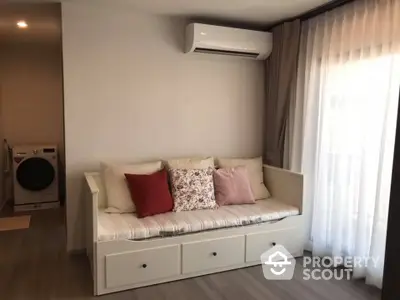 Cozy living room with modern sofa and washing machine in corner