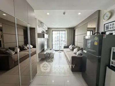 Modern living room with sleek design, mirrored walls, and large windows offering city views.