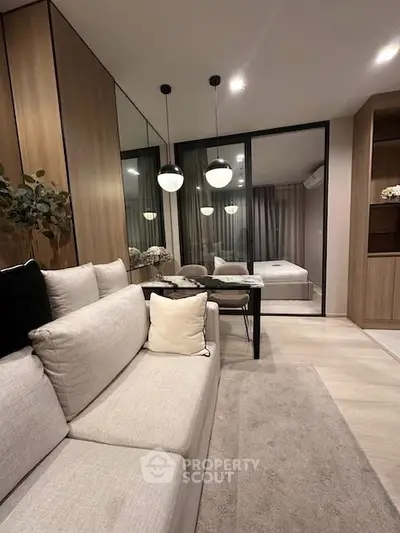 Modern living room with elegant decor and cozy ambiance, featuring a stylish sofa and contemporary lighting.