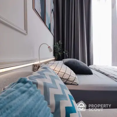 Modern bedroom with stylish decor and cozy ambiance, featuring elegant bedding and soft lighting.