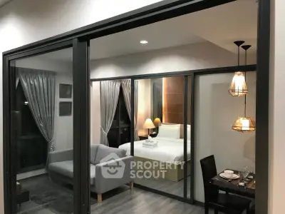 Modern apartment interior with glass partition, cozy living room, and elegant dining area.