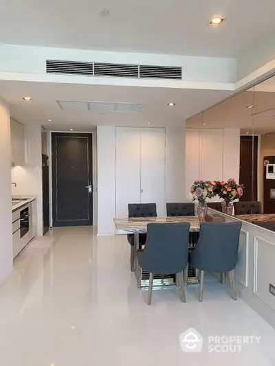 Modern dining area with sleek kitchen in open layout apartment