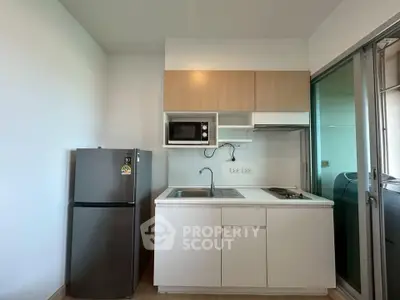 Modern compact kitchen with sleek appliances and minimalist design